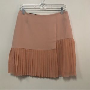 Dalia A-symmetrical blush pink pleated skirt fully lined size 4. Side zip